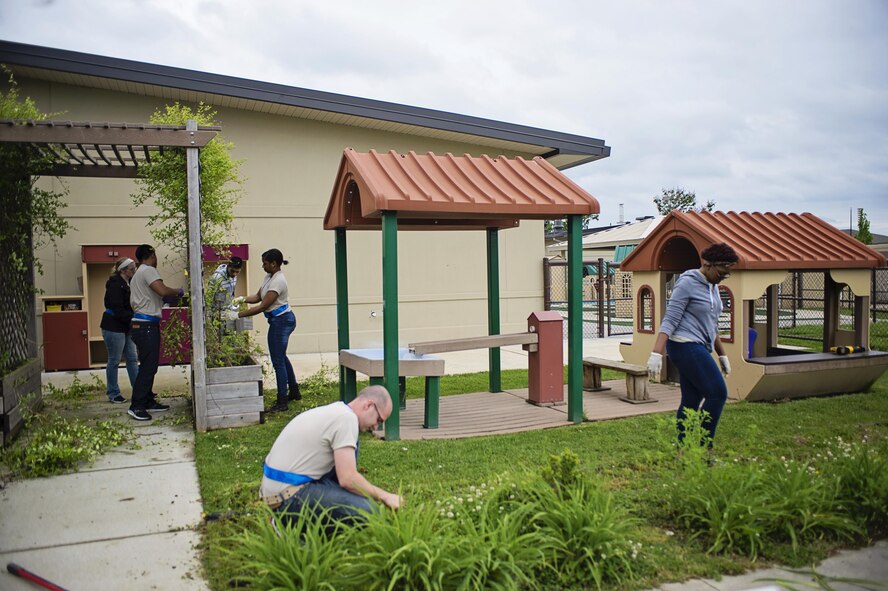 Members of the 512th Airlift Wing's Developmental & Training Flight clean up the playground at the Child Development Center on Dover Air Force Base, Del., May 21, 2016, during the wing's Unit Training Assembly. The D&TF is a unit that trains future reservists on what to expect during Basic Military Training and an overview of Air Force culture. (U.S. Air Force photo/Capt. Bernie Kale)