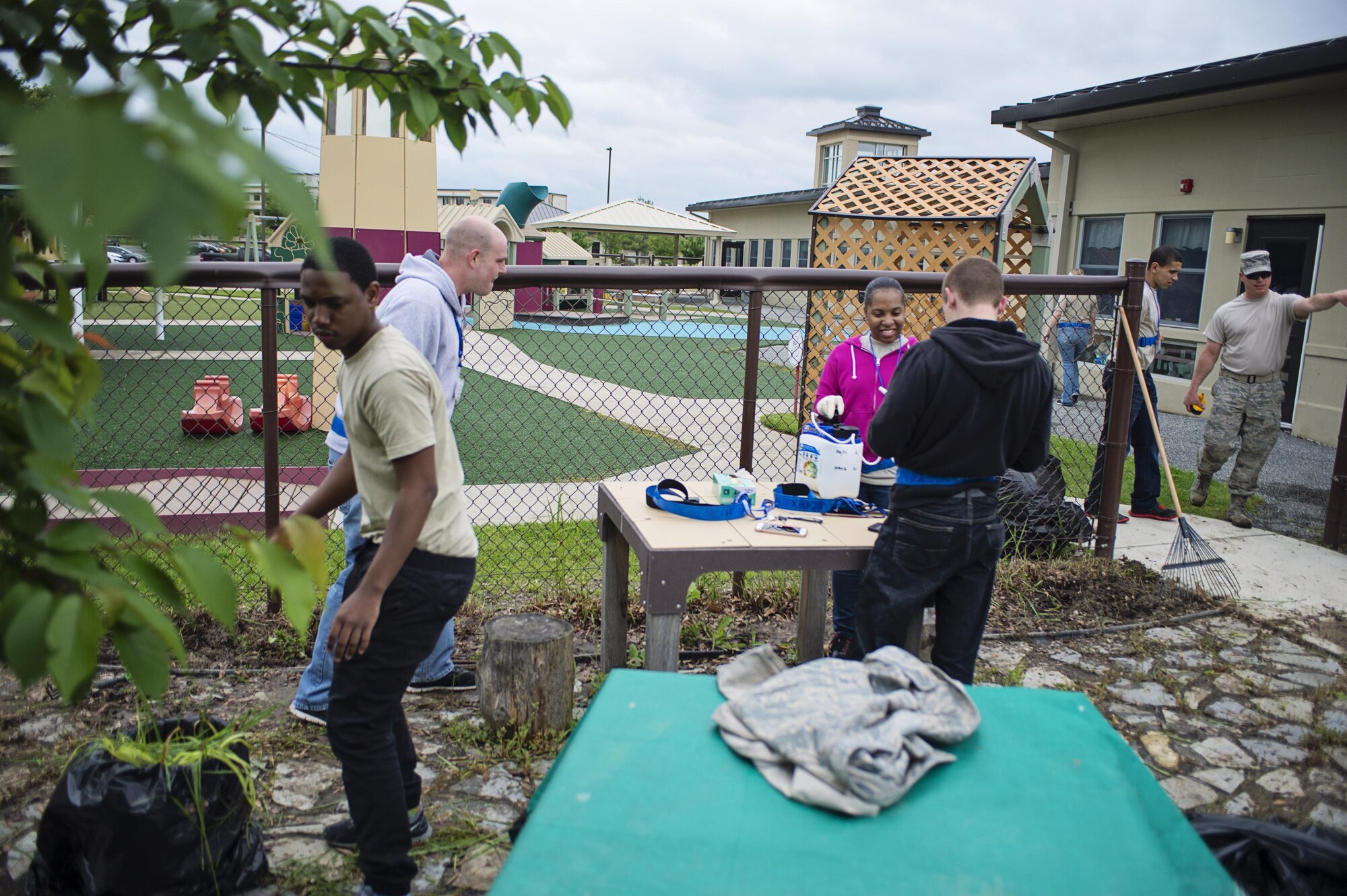 Members of the 512th Airlift Wing's Developmental & Training Flight clean up the playground at the Child Development Center on Dover Air Force Base, Del., May 21, 2016, during the wing's Unit Training Assembly. The D&TF is a unit that trains future reservists on what to expect during Basic Military Training and an overview of Air Force culture. (U.S. Air Force photo/Capt. Bernie Kale)
