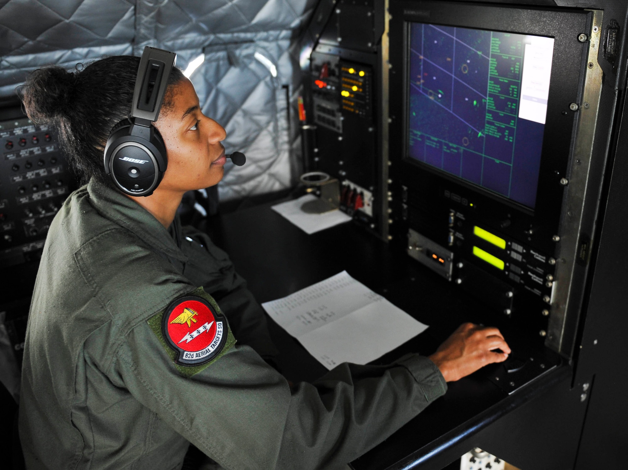 Technical Sgt. Latisha Russell, 82nd Aerial Target Squadron airborne mission systems operator, monitors the sea surveillance radar on the E-9A Widget, May 19. The Widget sweeps the Gulf of Mexico, gathers data, and sends it to the range safety officer, allowing him to build the shoot pattern to safely test weapons during a Weapons System Evaluation Program. (U.S. Air Force photo by Senior Airman Dustin Mullen/Released)