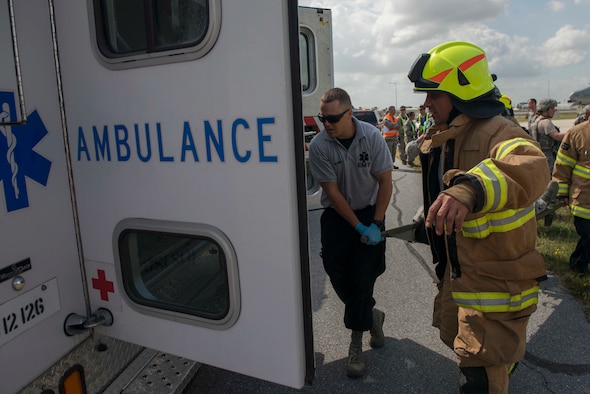 Personnel from the 39th Medical Group and Civil Engineer Squadron transport a simulated victim into an ambulance during an exercise May 18, 2016, at Incirlik Air Base, Turkey. MDG and CES personnel worked together to evacuate simulated casualties. (U.S. Air Force photo by Senior Airman John Nieves Camacho/Released)