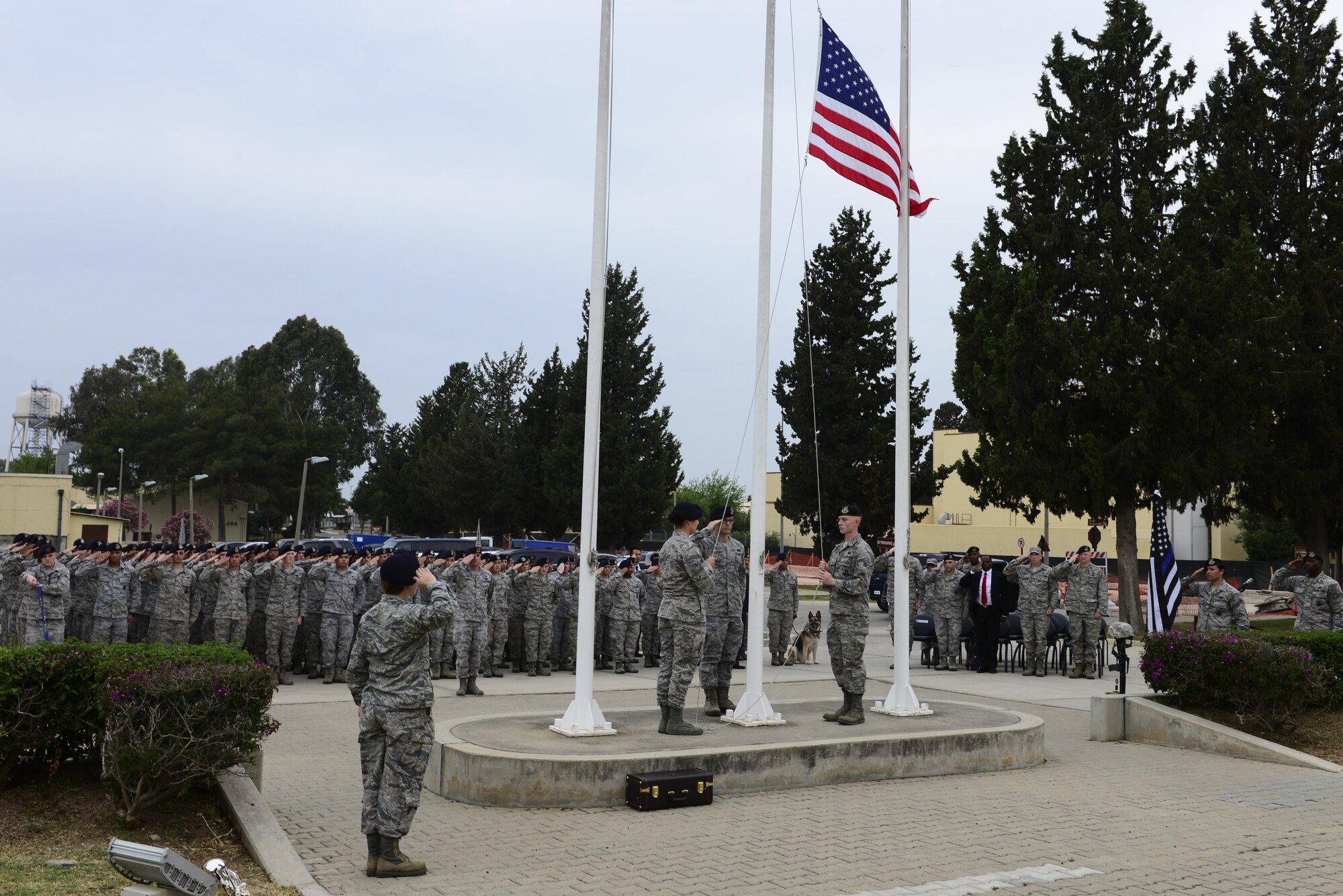 Members of the 39th Security Forces Squadron retrieve the U.S. flag during a National Police Week retreat ceremony May 15, 2016, at Incirlik Air Base, Turkey. National Police Week is dedicated to recognizing law enforcement officers who lost their lives in the line of duty. (U.S. Air Force photo by Staff Sgt. Caleb Pierce/Released)