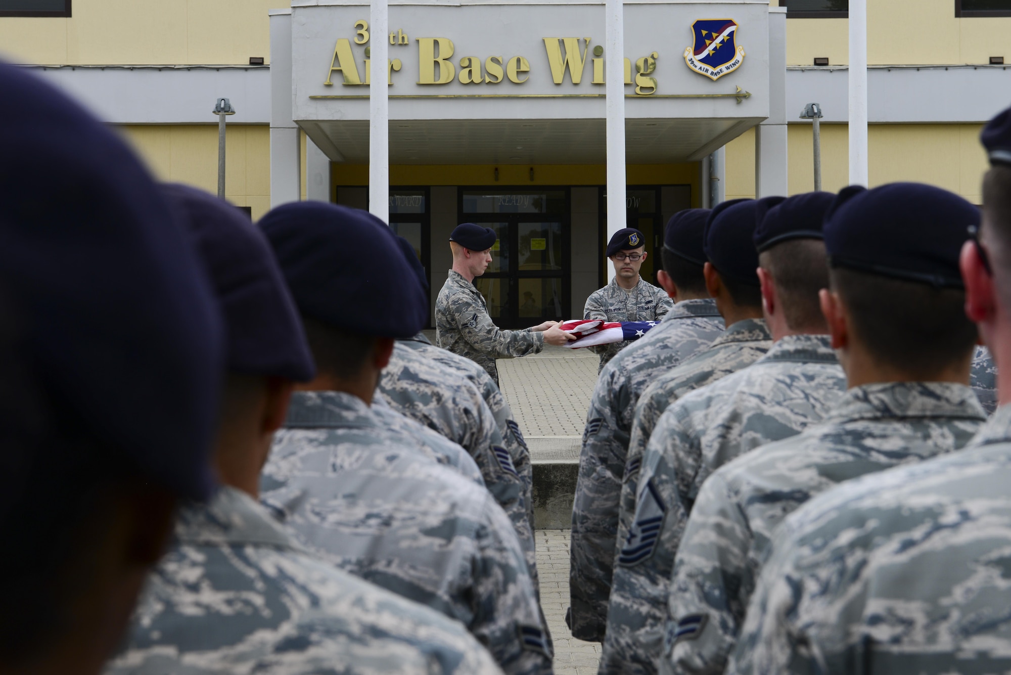 Members of the 39th Security Forces Squadron fold a flag during National Police Week retreat ceremony May 15, 2016, at Incirlik Air Base, Turkey. The folding of the flag concluded the ceremony. (U.S. Air Force photo by Staff Sgt. Caleb Pierce/Released)