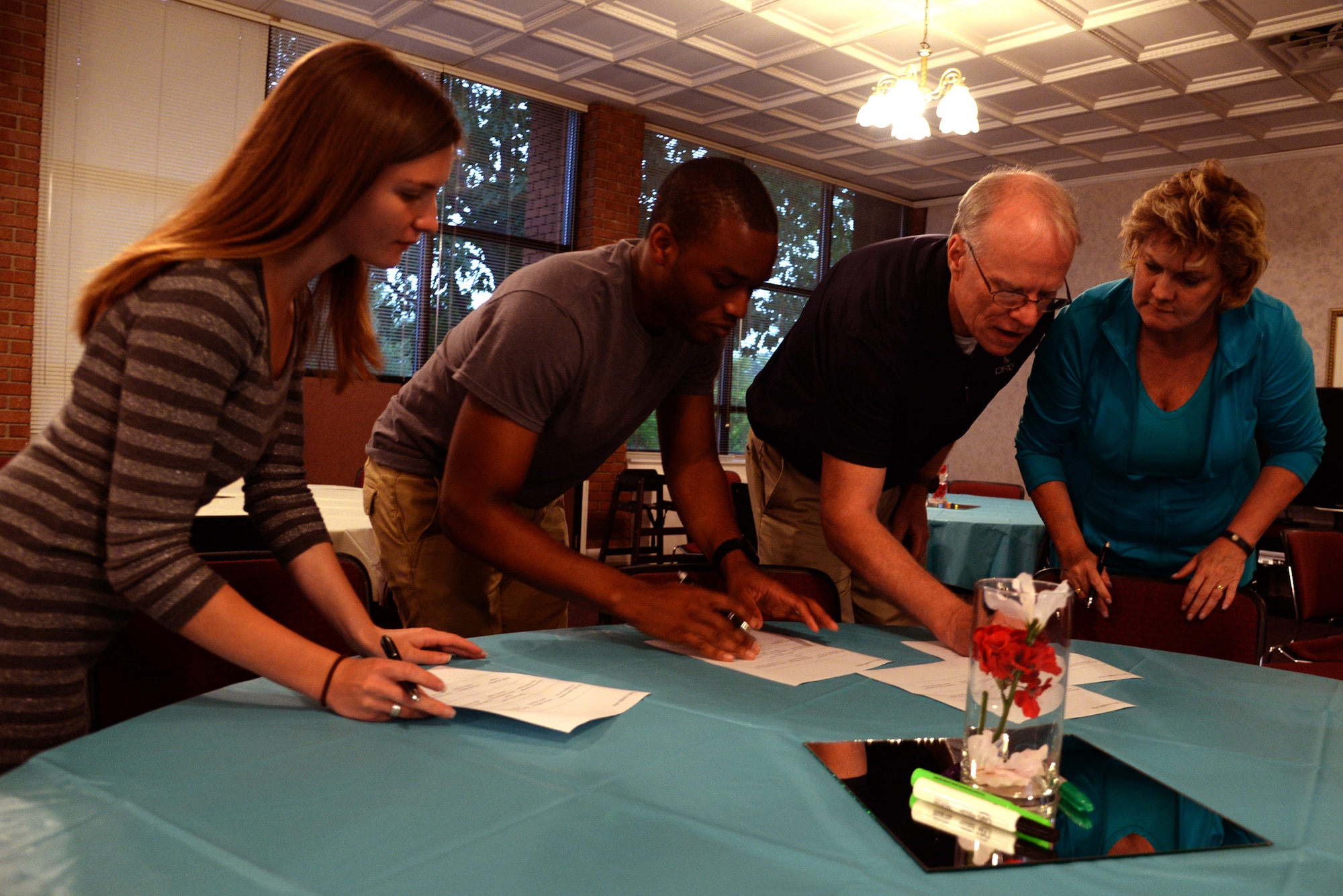 Participants in a 4th Fighter Wing Chaplain Corps sponsored marriage enrichment event, complete a team-building exercise to learn facts about other couples in the class, May 20, 2016, at Seymour Johnson Air Force Base, North Carolina. Couples of varying marriage lengths learned to enhance communication and how proper forgiveness can lift a burden on a relationship. (U.S. Air Force photo/Staff Sgt. Chuck Broadway)