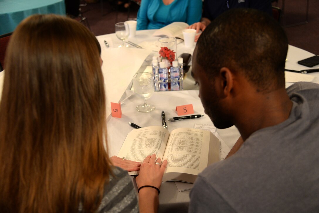 Senior Airman Charles Amara, 4th Medical Support Squadron health services administrator, and his wife Sarah, read a book titled "Fighting for Your Marriage," during a class of the same name, May 20, 2016, at Seymour Johnson Air Force Base, North Carolina. The couple has been married for more than two years and took the class to apply new concepts to their relationship. (U.S. Air Force photo/Staff Sgt. Chuck Broadway)