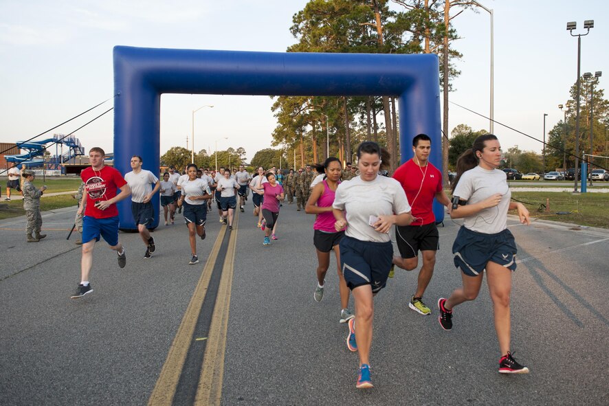Runners take off from the start line during a Memorial Day 5k/10k, May 26, 2016, at Moody Air Force Base, Ga. The 5k started behind the Freedom 1 Fitness Center and continued along the trail towards the flightline. (U.S. Air Force photo by Airman 1st Class Lauren M. Hunter/Released)