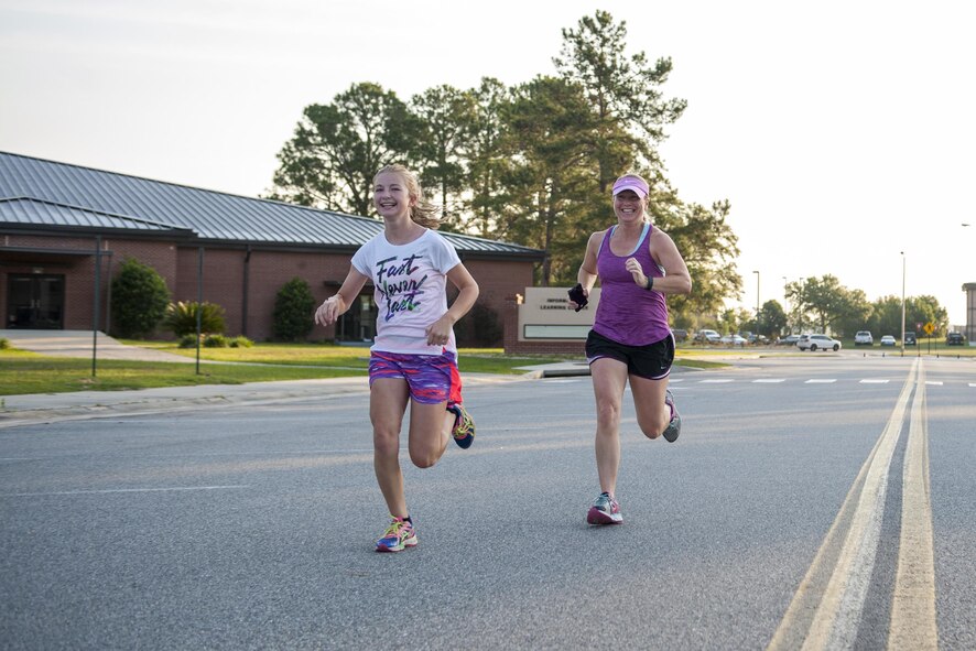 Erin and Jessica Locke, wife and daughter of U.S. Air Force Col. Joseph Locke, 93d Air Ground Operations Wing commander, run toward the finish line during a Memorial Day 5k/10k, May 26, 2016, at Moody Air Force Base, Ga. The 5k was held to encourage Airmen and families to maintain their health and wellness. (U.S. Air Force photo by Airman 1st Class Lauren M. Hunter/Released)