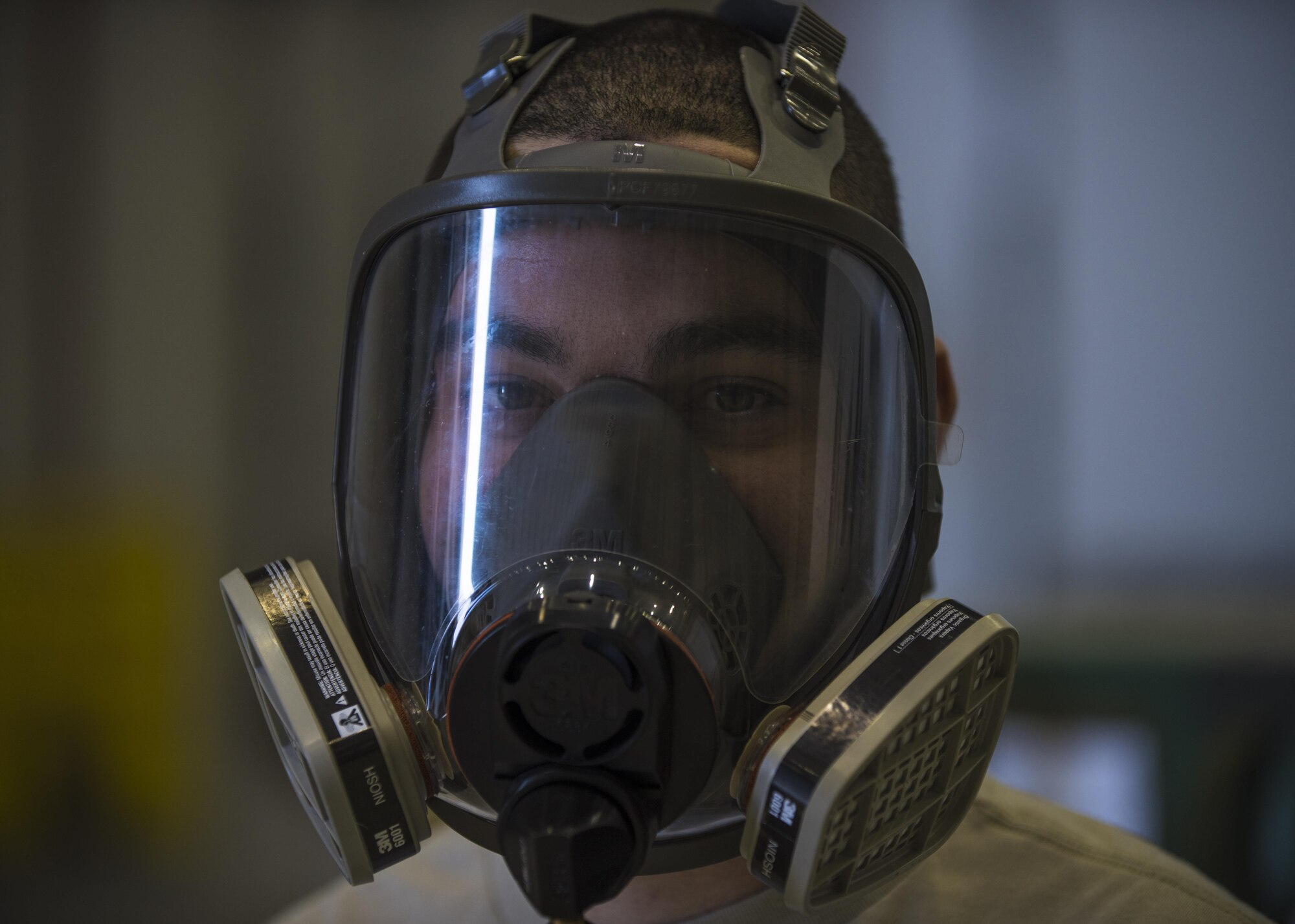 Senior Airman Craig Martin, 455th Expeditionary Aircraft Maintenance Squadron fuels system specialist, wears a 3M 7800 respirator at Bagram Airfield, Afghanistan, May 24, 2016. Fuel systems specialists use the respirator to breath in fresh oxygen while in the C-130J Super Hercules fuel tanks because without it, it would lead to nausea, dizziness, headaches, etc. (U.S. Air Force photo by Senior Airman Justyn M. Freeman)