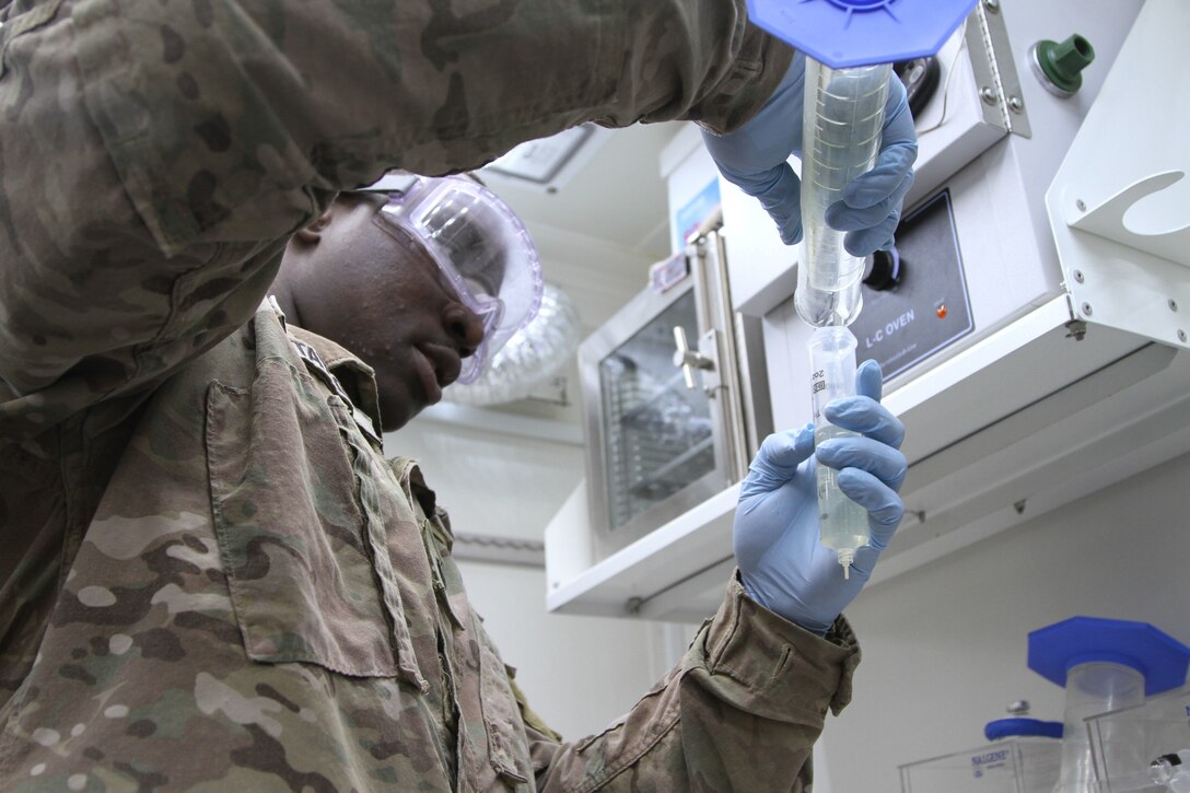 U.S. Army Spc. Terek E. Taylor, petroleum laboratory specialists with Alpha Company, 640th Aviation Sustainment Battalion, 40th Combat Aviation Brigade, performs quality surveillance of fuel received, at Camp Arifjan, Kuwait, June 14, 2016. The 1st Sustainment Command (Theater) performs laboratory inspections quarterly and annually. (U.S. Army photo by Sgt. 1st Class Naurys Marte/Released)
