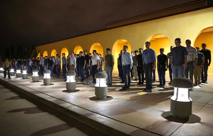 New recruits of Alpha Company, 1st Recruit Training Battalion, are welcomed to the depot as they stand on the yellow footprints during receiving at Marine Corps Recruit Depot San Diego, May 23. Once the recruits step off the bus, they immediately begin the transformation from civilian to Marine. Annually, more than 17,000 males recruited from the Western Recruiting Region are trained at MCRD San Diego. Alpha Company is scheduled to graduate Aug. 19.