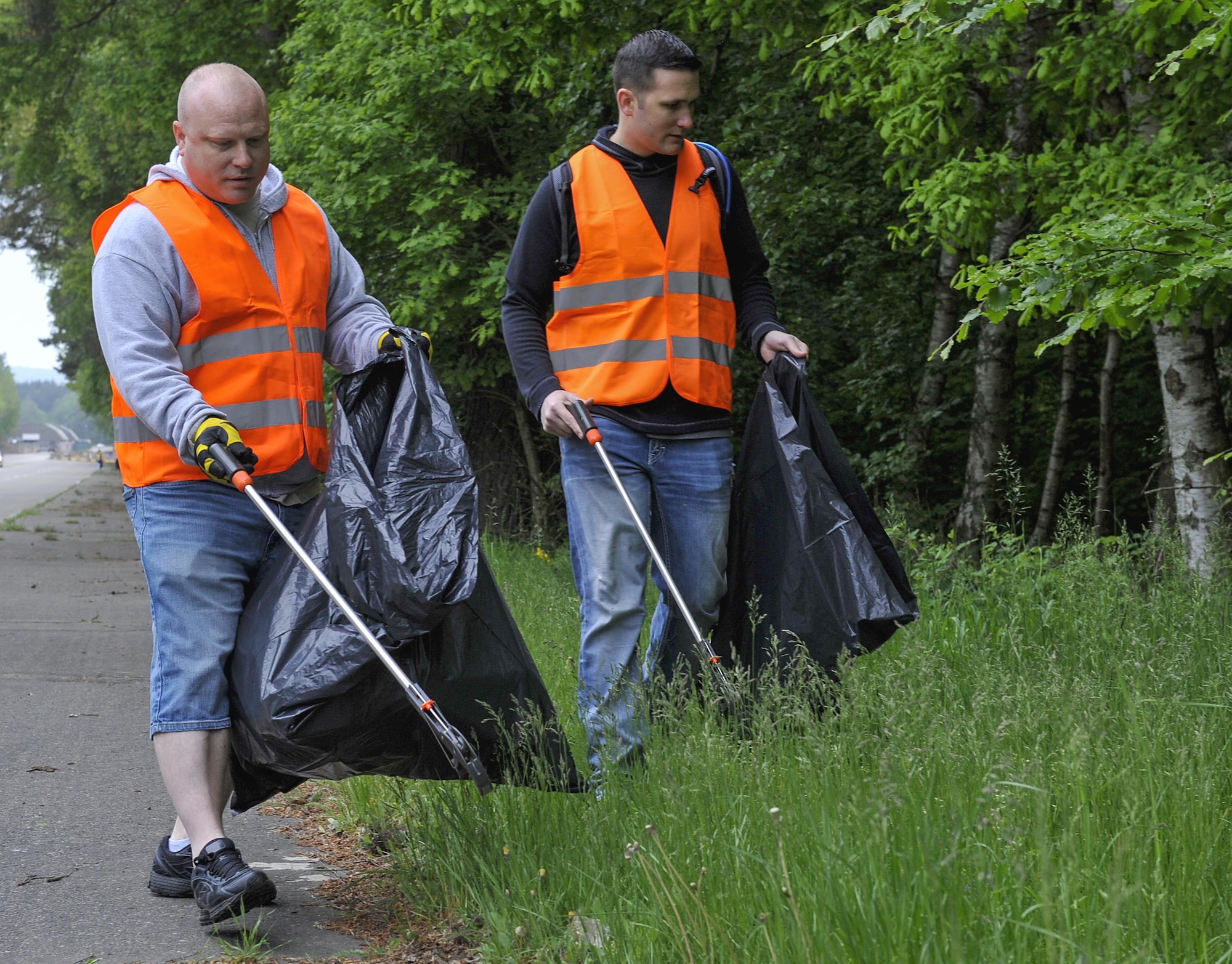 Volunteers pick up trash during an off-base clean-up event May 20, 2016, at Ramstein Air Base, Germany. These efforts are one of many ways Team Ramstein assists in ensuring Ramstein and its surrounding areas stay in top shape. (U.S. Air Force photo/Senior Airman Larissa Greatwood)
