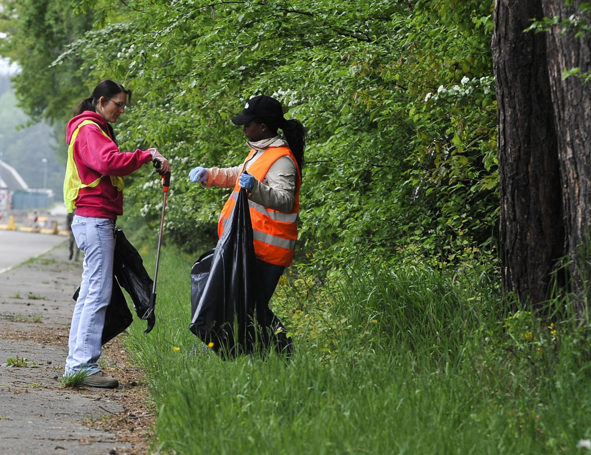 Volunteers pick up trash during an off-base clean-up event May 20, 2016, at Ramstein Air Base, Germany. Approximately 30 volunteers participated in ensuring the environment outside of Ramstein Air Base is kept clean. (U.S. Air Force photo/Senior Airman Larissa Greatwood)