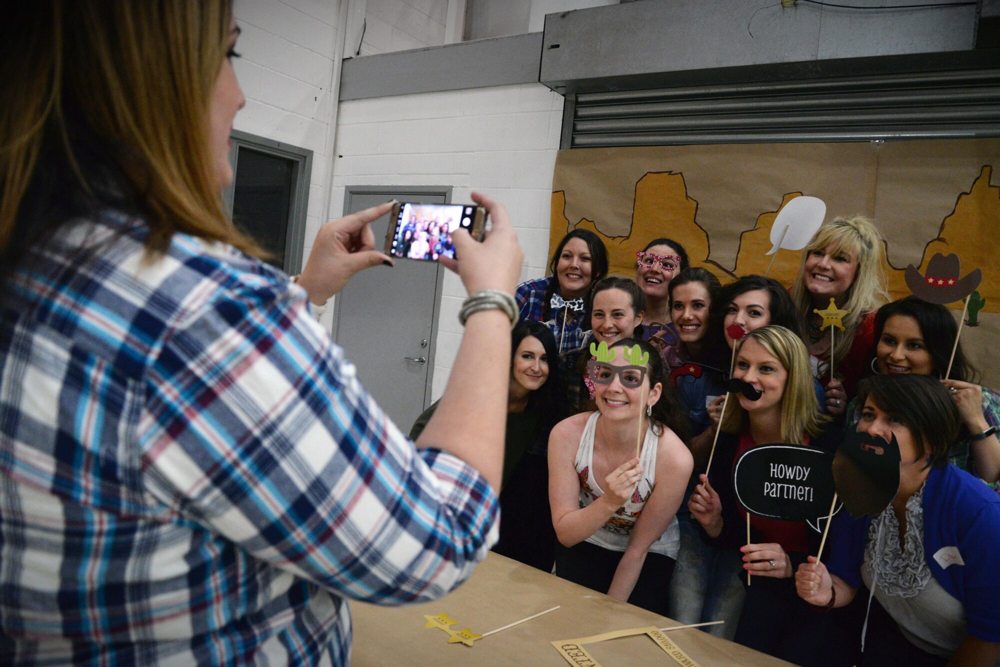 Team Mildenhall spouses pose for a photo during the Spouse Appreciation Dinner May 24, 2016, on RAF Mildenhall, England. The dinner was hosted by the Mildenhall Spouses’ Club and enabled spouses to come together and celebrate their appreciation of each other. (U.S. Air Force photo by Senior Airman Christine Halan/Released)