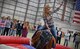 Lacey Keifer, 100th Civil Engineer Squadron spouse, rides the mechanical bull at the Spouse Appreciation Dinner May 24, 2016, on RAF Mildenhall, England. Spouses also had a barbecue dinner, and participated in line dancing and games. (U.S. Air Force photo by Senior Airman Christine Halan/Released)