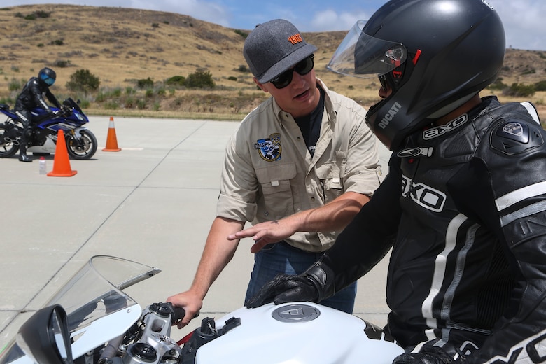 Cpl. Jacob Raap, a volunteer supervisor at Motorcycle Rider Preservation Day 2016, offers a rider tips on body positioning when coming to a quick stop from a high speed at the workshop set up on the helicopter landing field turned motorcycle track in San Mateo Canyon on Marine Corps Base Camp Pendleton, Calif., May 20. Marine Aircraft Group 39 partnered with Marine Corps Base Camp Pendleton Motorcycle Safety Division to host Motorcycle Rider Prevention Day 2016 for 3rd MAW service members who own bikes. (U.S. Marine Corps photo by Lance Cpl. Harley Robinson/Released)