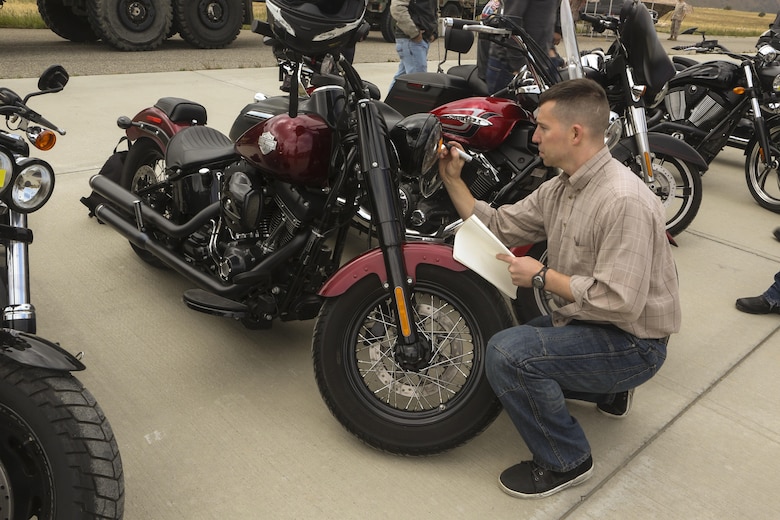 Maj. Aaron Milroy, director of safety and standardization for MAG-39, conducts inspections on the motorcycles during Motorcycle Rider Preservation Day 2016 in San Mateo Canyon on Marine Corps Base Camp Pendleton, Calif., May 20. Marine Aircraft Group 39 partnered with Marine Corps Base Camp Pendleton Motorcycle Safety Division to host Motorcycle Rider Preservation Day 2016 for 3rd Marine Aircraft Wing service members who own bikes. (U.S. Marine Corps photo by Lance Cpl. Harley Robinson/Released)