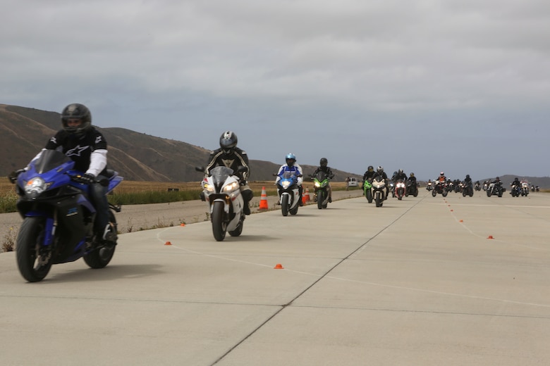 Service members with 3rd Marine Aircraft Wing ride on the helicopter landing field turned motorcycle track during Motorcycle Rider Preservation Day 2016 in San Mateo Canyon on Marine Corps Base Camp Pendleton, Calif., May 20. Marine Aircraft Group 39 partnered with Marine Corps Base Camp Pendleton Motorcycle Safety Division to host Motorcycle Rider Preservation Day 2016 for 3rd MAW service members who own bikes. (U.S. Marine Corps photo by Lance Cpl. Harley Robinson/Released)