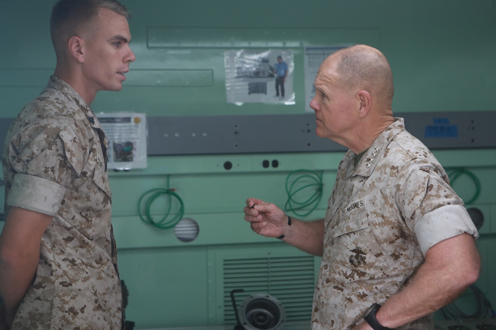 U.S. Marine Corps Cpl. Samuel Stonestreet, ground radio repairman, Repairable Management Company, 1st Maintenance Battalion, Combat Logistics Regiment 15, 1st Marine Logistics Group talks with Gen. Robert Neller, Commandant of the Marine Corps about the front line capabilities of the Expeditionary Manufacturing System on Camp Pendleton, Calif., May 24, 2016. The Expeditionary Manufacturing System is a mobile 3D printing and milling shop designed to provide quick turnaround for mission critical parts in deployed environment. (U.S. Marine Corps photo by Sgt. Rodion Zabolotniy, Combat Camera, Camp Pendleton/RELEASED)