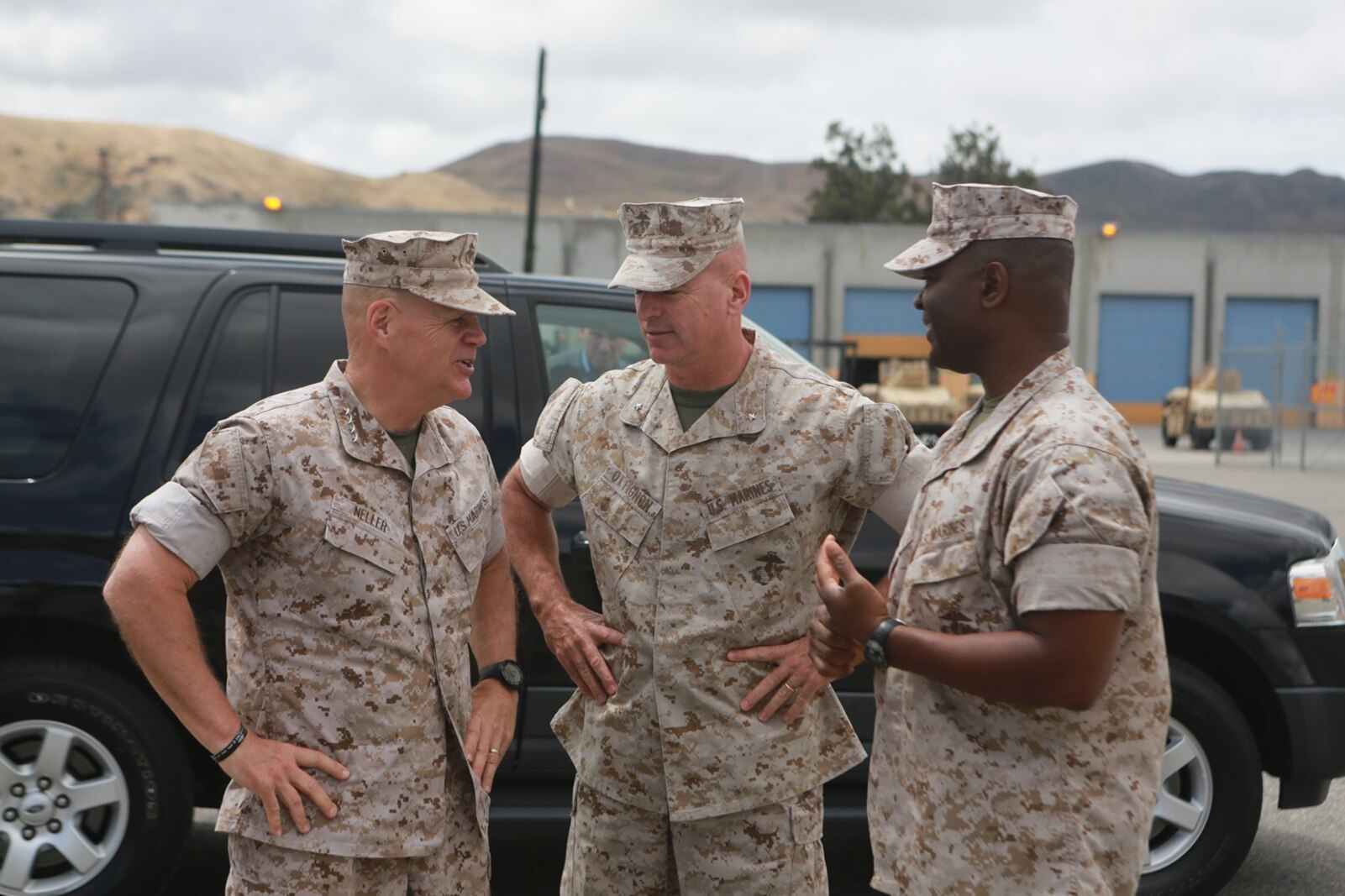 U.S. Marine Corps Gen. Robert Neller, Commandant of the Marine Corps, Brig. Gen. David Ottignon, commanding general, 1st Marine Logistics Group, and Col. Seth Ocloo, commanding officer, Combat Logistics Regiment 15, 1st MLG, talk about the current and future 3D printing operations using the Expeditionary Manufacturing System within the 1st MLG on Camp Pendleton, Calif., May 24, 2016. The Expeditionary Manufacturing System is a mobile 3D printing and milling shop designed to provide quick turnaround for mission critical parts in deployed environment. (U.S. Marine Corps photo by Sgt. Rodion Zabolotniy, Combat Camera, Camp Pendleton/RELEASED)