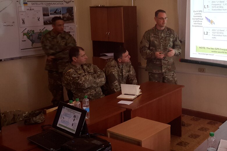 Lt. Col. Siegfried Ullrich, G31, U.S. Army Space and Missile Defense Command/Army Forces Strategic Command, right, provides an introduction to space operations during a two-day training session for Ukrainian officers.