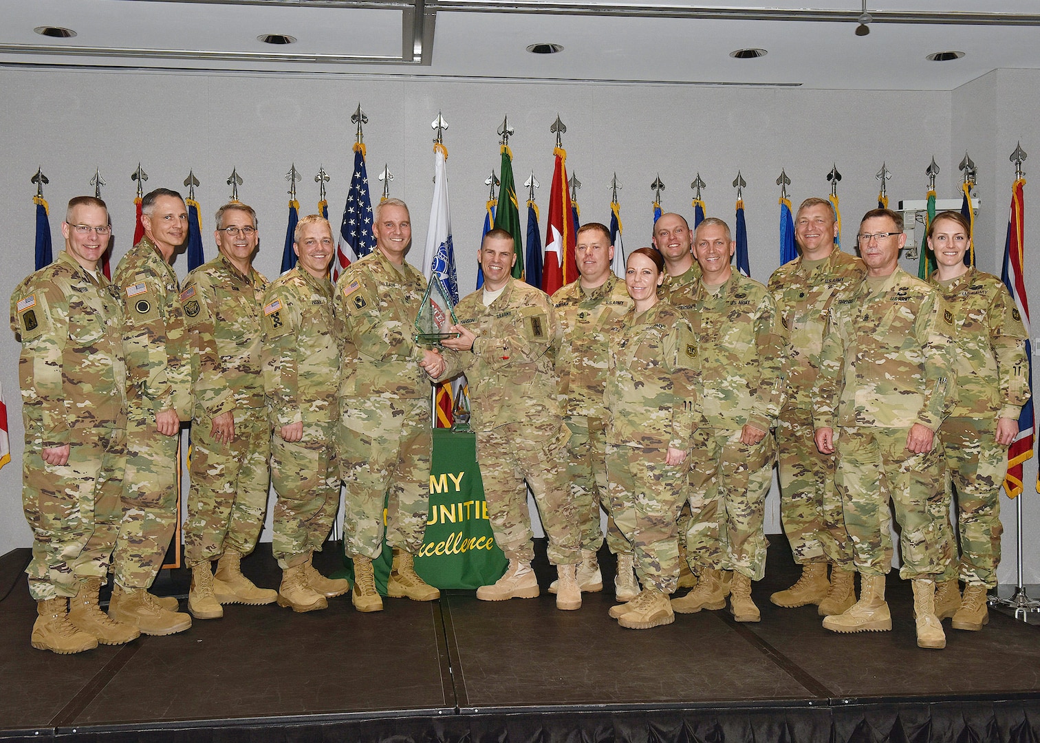 Army Maj. Gen. Richard Gallant, special assistant to the director of the Army National Guard, presents Wisconsin National Guard representatives with the Overall Winner of the Army National Guard Communities of Excellence award at a ceremony held at the Army National Guard Readiness Center in Arlington, Va., May 23, 2016.