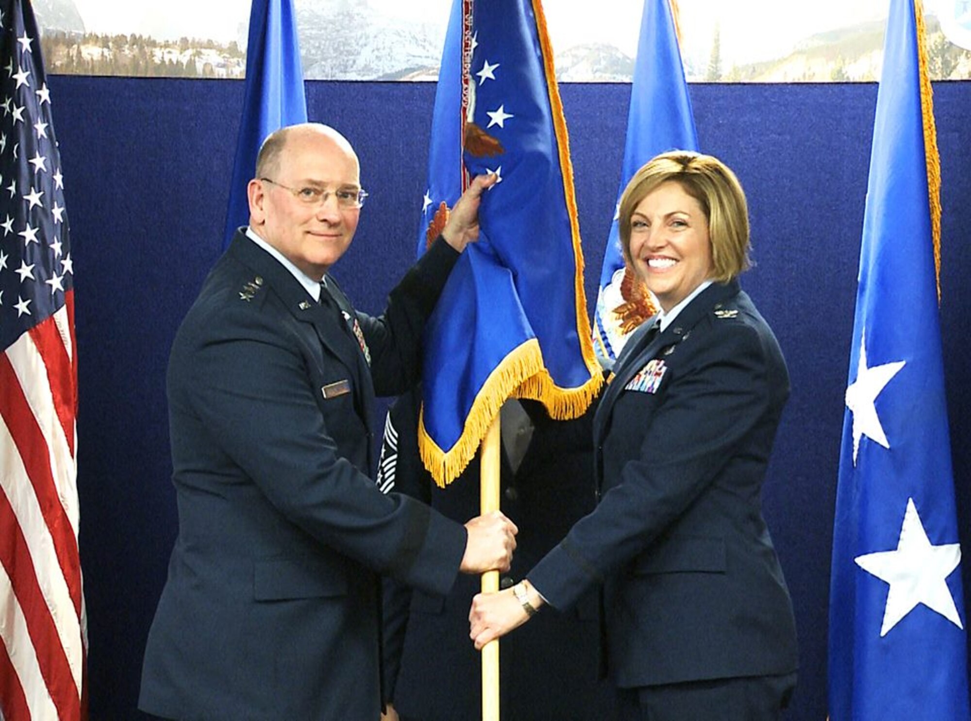 Lt. Gen. James “JJ” Jackson, chief of the Air Force Reserve and commander of the Air Force Reserve Command, passes the Air Reserve Personnel Center guidon to Col. Ellen M. Moore, incoming ARPC commander, during a change of command ceremony held May 26, 2016, on Buckley Air Force Base, Colo. Moore, the former Director of Manpower, Personnel and Services, Headquarters Air Force Reserve Command, Robins Air Force Base, Ga., assumed command of ARPC from Mahaney, who left the center to serve as the the Reserve Deputy Director, Director of Operations, Air Mobility Command, Scott Air Force Base, Ill. (U.S. Air Force photo/Quinn Jacobson)