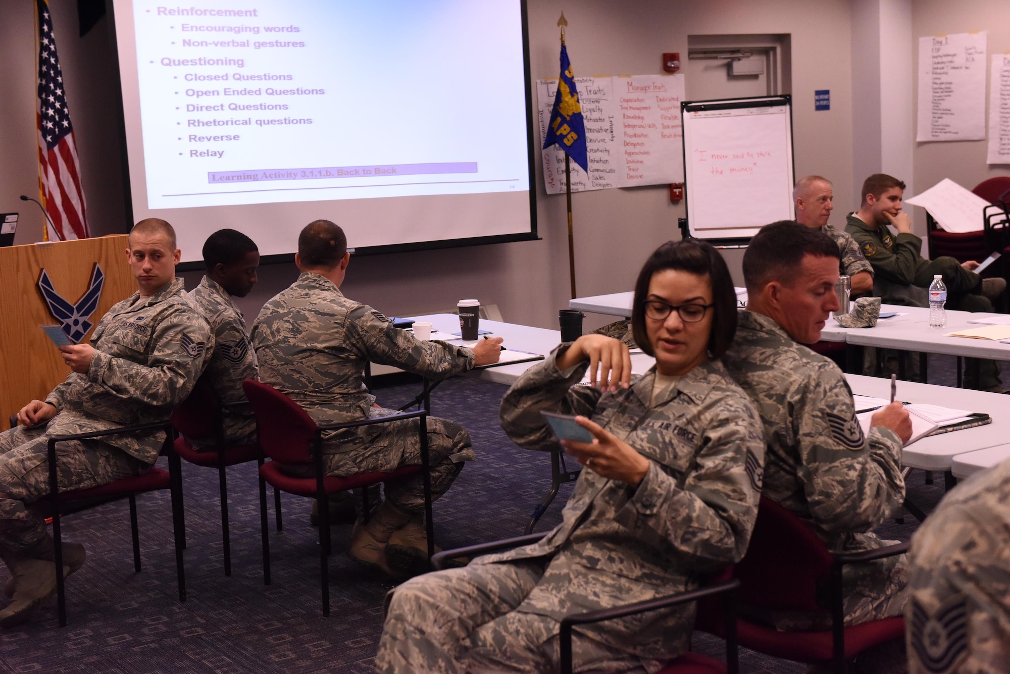 Staff Sgt. Danielle Miller, squadron medical element technician with the 758th Airlift Squadron, describes to her partner, Tech. Sgt. John Davis, fire team leader with the 911th Security Forces Squadron, how to draw what is on the card in front of her despite communication barriers in place, during the Air Force Reserve Command NCO Leadership Development Course held at the Pittsburgh International Airport Air Reserve Station, Pa., May 11, 2016. NCO’s were partnered up and placed back-to-back inhibiting them from using non-verbal communication to accomplish the task at hand, displaying the importance of effective communication and teamwork. The course provides mid-level enlisted personnel with hands-on experience in leadership and management practices through guided discussions, role-playing exercises, and learning activities. (U.S. Air Force photo by Staff Sgt. Jonathan Hehnly)