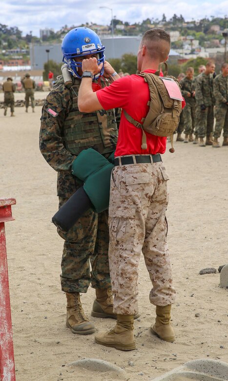 A drill instructor with Bravo Company, 1st Recruit Training Battalion, inspects a recruit’s gear during Pugil Sticks III at Marine Corps Recruit Depot San Diego, May 24. Each recruit’s gear was inspected by a drill instructor to ensure it was tight enough to endure any hits from a pugil stick. Annually, more than 17,000 males recruited from the Western Recruiting Region are trained at MCRD San Diego. Bravo Company is scheduled to graduate June 17.