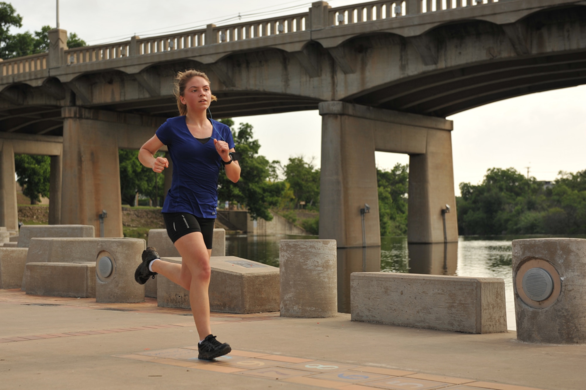 U.S. Air Force Airman 1st Class Alicia Hansen, 316th Training Squadron student, runs across Celebration Bridge during the Lt. Goodfellow 7.5k run in San Angelo, Texas, May 21, 2016. Goodfellow Air Force Base hosted the run to celebrate its 75th anniversary and the birth of 1st Lt. John J. Goodfellow. (U.S. Air Force by Airman 1st Class Caelynn Ferguson/Released)
