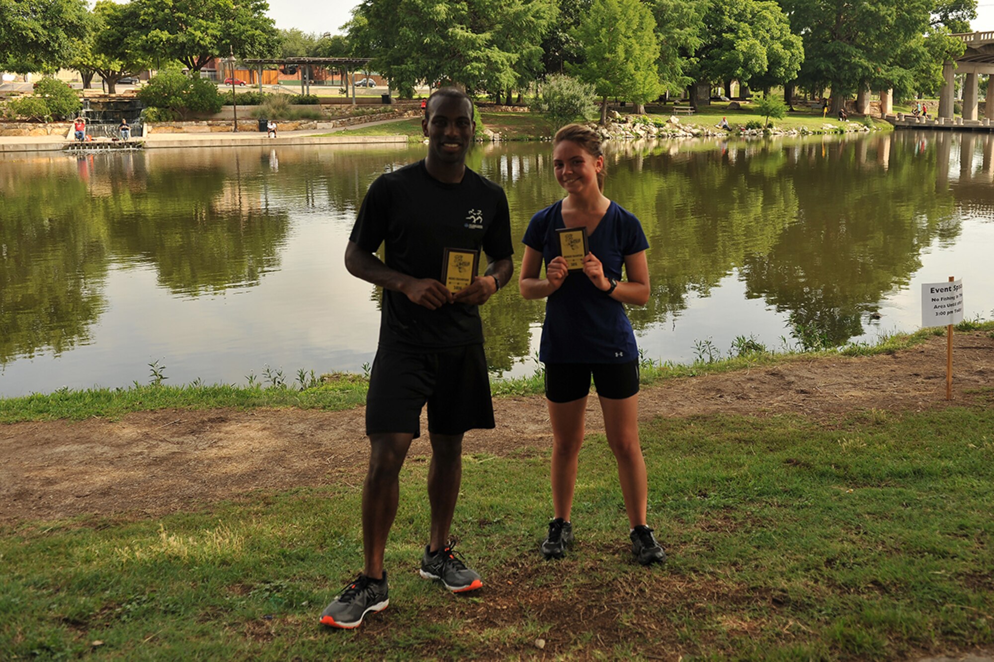 U.S. Air Force Airmen 1st Class Jamar Davis and Alicia Hansen, 316th Training Squadron students, hold their awards for being the fastest male and female runners in the Lt. Goodfellow 7.5k run at the Concho River in San Angelo, Texas, May 21, 2016. Goodfellow Air Force Base celebrated the anniversary of 1st Lt. John J. Goodfellow’s birth and the 75th anniversary of the base with the run. (U.S. Air Force by Airman 1st Class Caelynn Ferguson/Released)