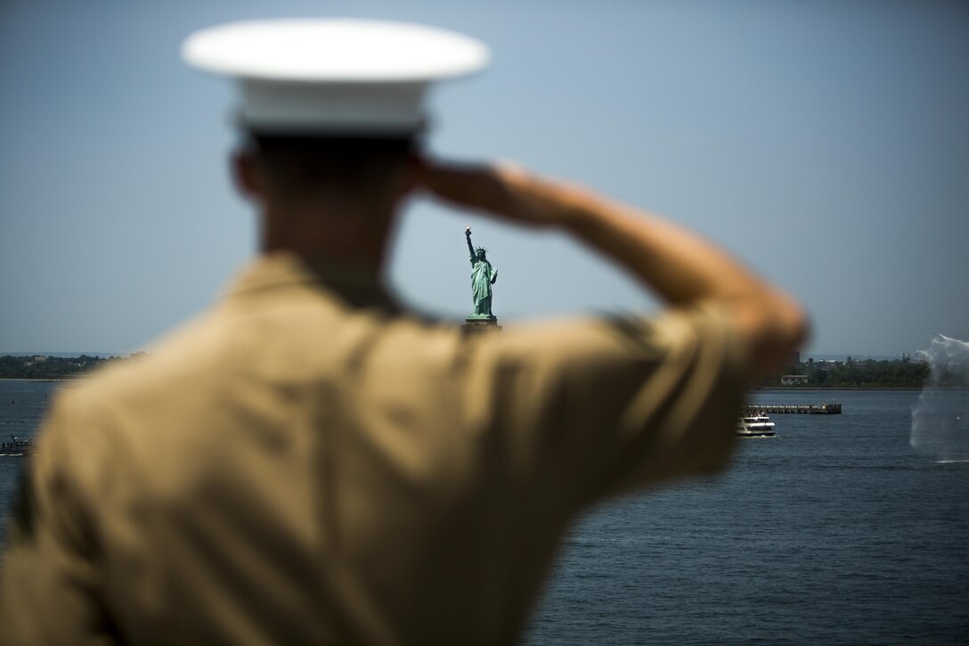U.S. Marine Corps Cpl. Seth Hall, anti-tank missileman, 3rd Battalion, 6th Marine Regiment, mans the rails of USS Bataan in a parade of ships as part of Fleet Week in New York, May 25, 2016. The USS Bataan transported more than 500 Marines and sailors with the 24th Marine Expeditionary Unit who will participate in this year’s Fleet Week.