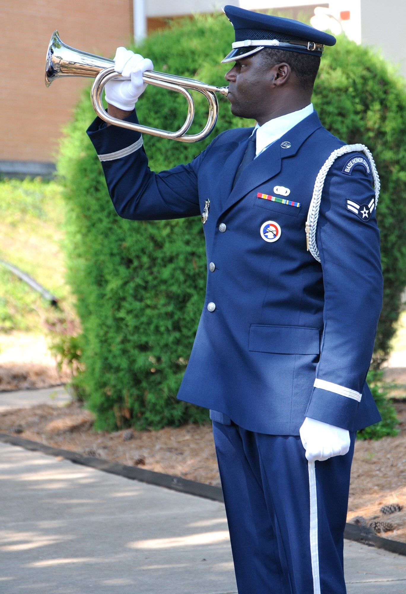 Airman 1st Class Bernard Davis, 14th Flying Traiing Wing Honor Guardsman, plays Taps during the Memorial Day Retreat Ceremony May 26 at Columbus Air Force Base, Mississippi. Memorial Day, observed on the last Monday of May, honors men and women who died while serving in the U.S. military. (U.S. Air Force photo/Melissa Doublin)