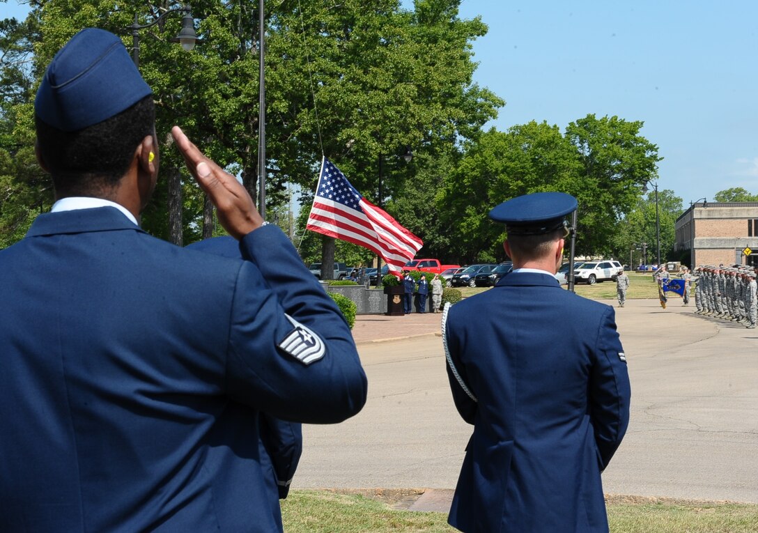 Team BLAZE Airmen and civilians render their respect to fallen warriors while the U.S. flag is lowered during the Memorial Day Retreat Ceremony May 26 at Columbus Air Force Base, Mississippi. On Memorial Day the flag is displayed at half-staff until noon and at full staff from noon to sunset. This unique custom honors the war dead for the morning, and living veterans for the rest of the day. (U.S. Air Force photo/Senior Airman Kaleb Snay)
