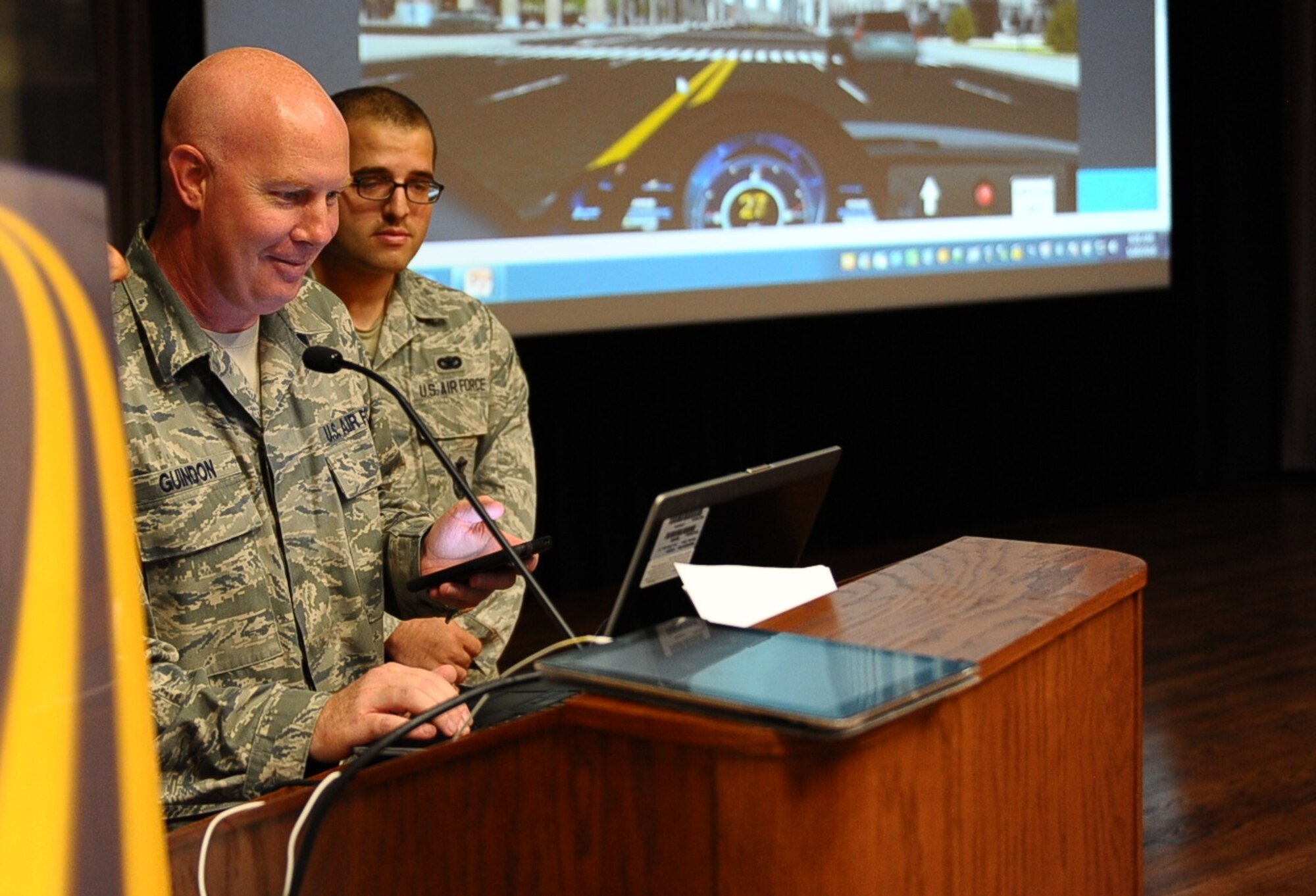 Master Sgt. Jean-Phillipe Guindon, 14th Communications Squadron Operations Flight Superintendent, volunteers to play a texting and driving game during a safety brief to demonstrate the dangers it can evoke May 26 at Columbus Air Force Base, Mississippi. The brief was one of three held on base to remind Team BLAZE members to be safe before the Memorial Day holiday. (U.S. Air Force photo/Senior Airman Kaleb Snay) 