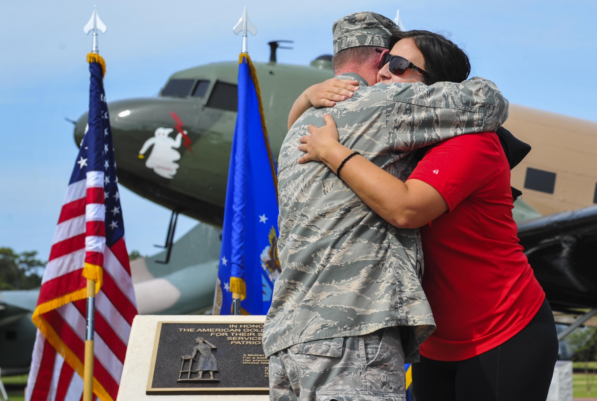 Maj. Gen. Eugene Haase, the vice commander of Air Force Special Operations Command, hugs Kalie Walters, a member of the Preservation of the Force and Family, during the Gold Star Mothers plaque dedication ceremony at Hurlburt Field, Fla., May 25, 2016. The plaque was presented to Lt. Gen. Brad Heithold, commander of AFSOC, by George Turak, a Vietnam veteran, during a ceremony held Sept. 18, 2015, to honor the family members of AFSOC’s fallen service members.  (U.S. Air Force photo by Airman 1st Class Joseph Pick)