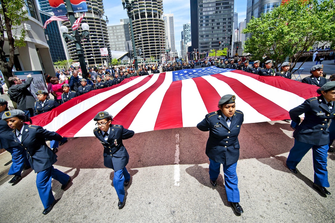 Junior ROTC cadets from a Chicago public school carry an American flag during Chicago's Memorial Day Parade, May 24, 2014. Army photo by Sgt. 1st Class Michel Sauret