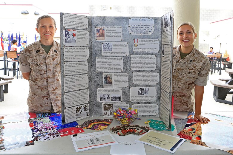 CAMP PENDLETON, Calif. --  Master Sgt. Tosha Reed, equal opportunity advisor with I Marine Expeditionary Force, and Sgt. Abbey Idalski, inspector general clerk with I MEF, showcase the Women's History Month exhibit during Camp Pendleton's Multi-Cultural Day at the Mainside Patio here, May 26. More than 40 Marines and civilians with Marine Corps Installations - West, 1st Marine Division, 1st Marine Logistics Group and I MEF set up booths and exhibits in order to foster a sense of unity among the diverse groups serving within the military.
