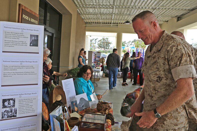 CAMP PENDLETON, Calif. -- Brig. Gen. Edward D. Banta, Commanding General, Marine Corps Installations - West, examines the National American Indian Heritage Month exhibit during Camp Pendleton's Multi-Cultural Day at the Mainside Patio here, May 26. More than 40 Marines and civilians with Marine Corps Installations - West, 1st Marine Division, 1st Marine Logistics Group and I Marine Expeditionary Force set up booths and exhibits in order to foster a sense of unity among the diverse groups serving within the military.