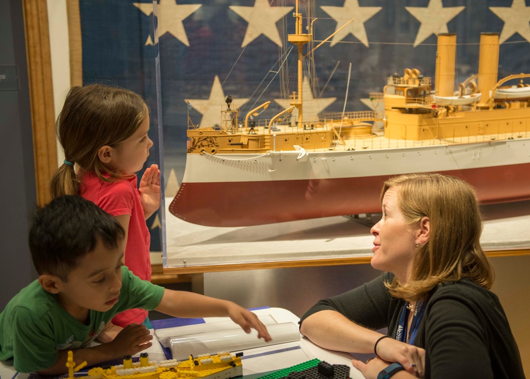 Laura Orr, deputy education director at Hampton Roads Naval Museum, teaches children about the exhibits after the launch of Blue Star Museums at the Hampton Roads Naval Museum, in Norfolk, Va., May 26, 2016. Blue Star Museums is a collaboration among the National Endowment for the Arts, Blue Star Families, the Department of Defense, and more than 2,000 museums across America to offer free admission to the nation's active duty military members and their families from Memorial Day through Labor Day. Navy photo by Petty Officer 3rd Class Amy M. Ressler