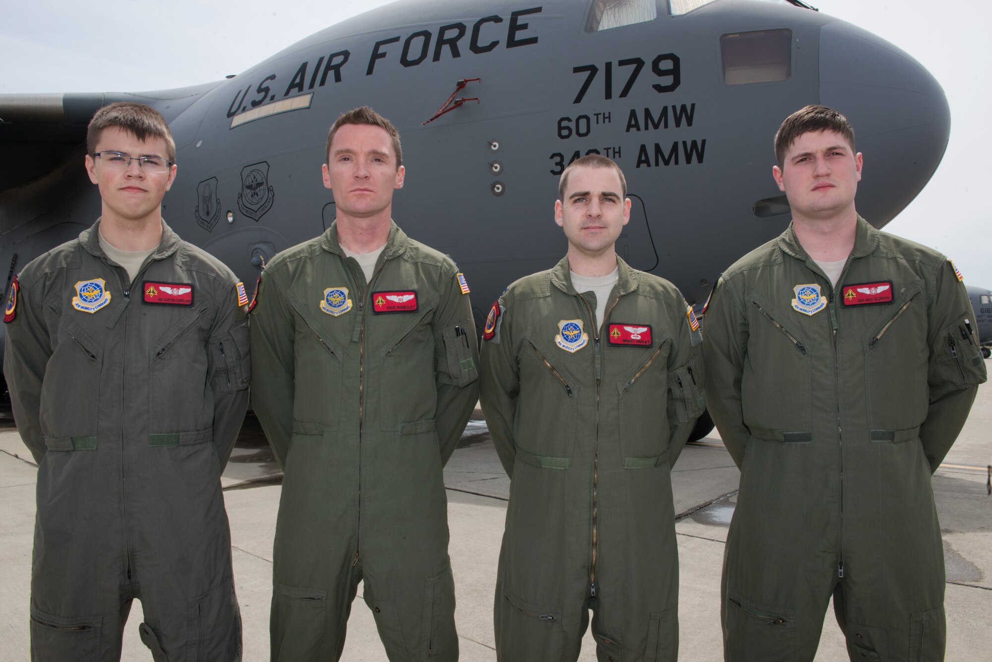 Pictured from left to right, Airman 1st Class Austen Copeland, Capt. Eric Rieboldt, Capt. Grant Hadley and Senior Airman Max Oldroyd, all assigned to the 21st Airlift Squadron, pose for a group picture on the flightline at Travis Air Force Base, Calif., April 26, 2016.  This aircrew evacuated injured Americans following the terrorist attacks in Brussels, Belgium. Not pictured but also part of the crew were 1st Lt. Justin Gross and Staff Sgt. Chase Decker. (U.S. Air Force photo by Louis Briscese)

