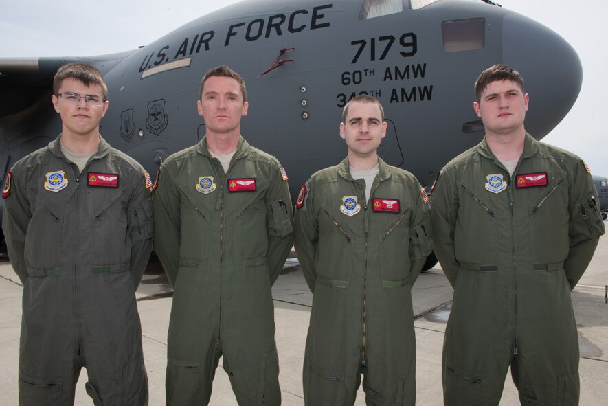 Pictured from left to right, Airman 1st Class Austen Copeland, Capt. Eric Rieboldt, Capt. Grant Hadley and Senior Airman Max Oldroyd, all assigned to the 21st Airlift Squadron, pose for a group picture on the flightline at Travis Air Force Base, Calif., April 26, 2016.  This aircrew evacuated injured Americans following the terrorist attacks in Brussels, Belgium. Not pictured but also part of the crew were 1st Lt. Justin Gross and Staff Sgt. Chase Decker. (U.S. Air Force photo by Louis Briscese)

