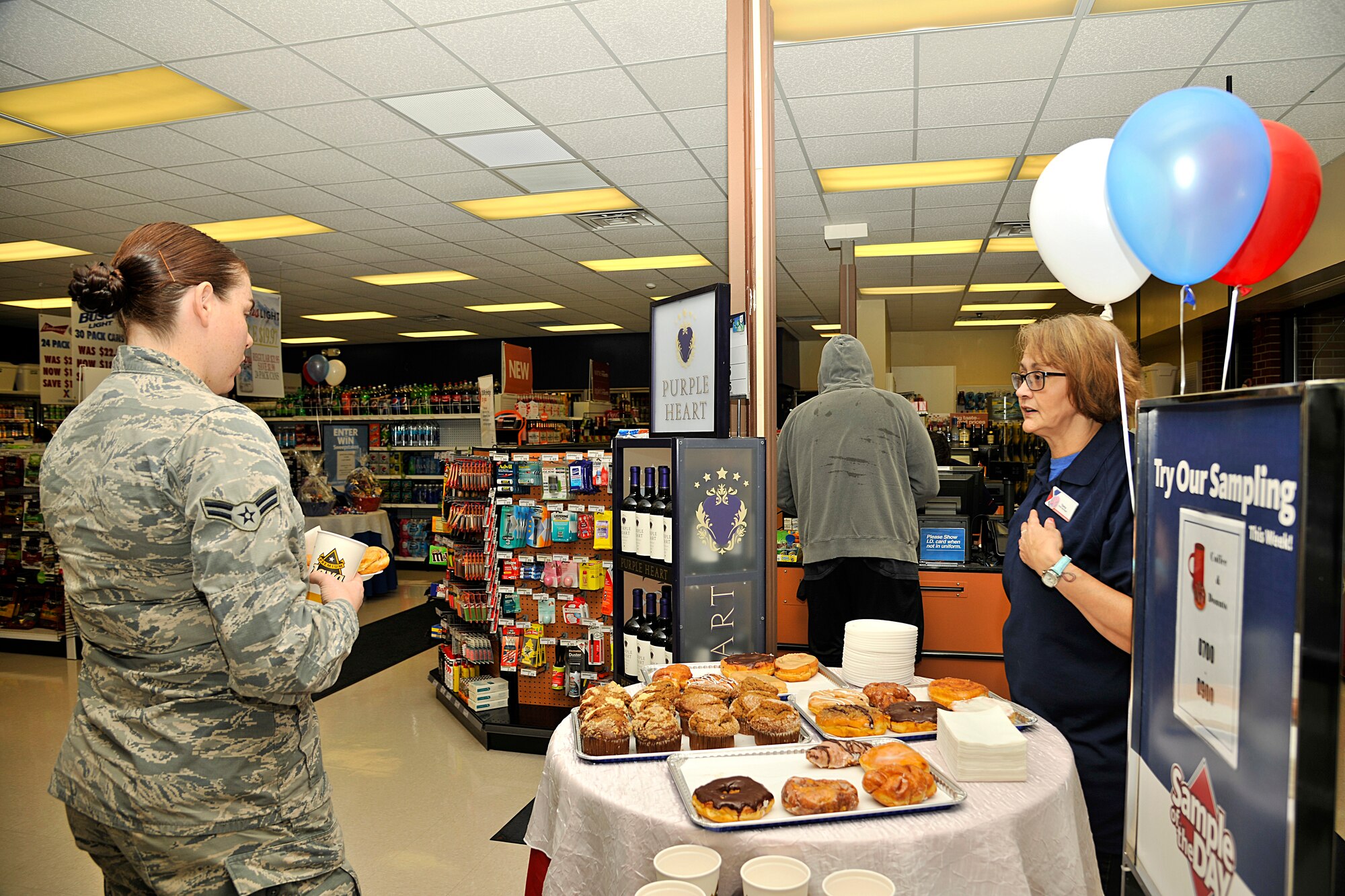 Airman 1st Class Lauren Schoenike, 319th Air Base Wing Public Affairs broadcaster, gets refreshments after the Grand Forks Express reopening ceremony May 23, 2016 on Grand Forks Air Force Base, N.D. Grand Forks AFB Express has been renovated to ensure a better shopping experience for Airmen and family members.  (U.S. Air Force photo/Senior Airman Xavier Navarro)