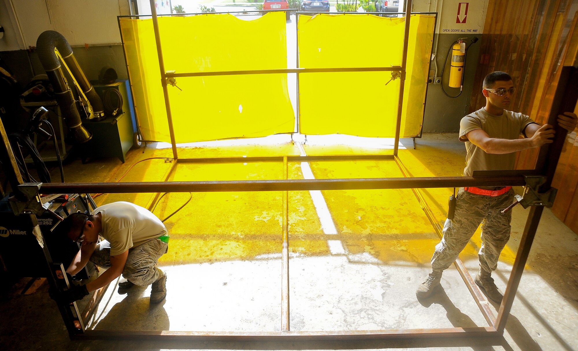 Staff Sgt. Armand Guting, left, and Senior Airman Andrew Flanagan, right, aircraft metals technology technicians with the 6th Maintenance Squadron, measure a side of the paint rack at MacDill Air Force Base, Fla., May 20, 2016. Once the rack is complete, the rack will be placed into the corrosion control facility paint booth where it will hold parts that can be painted from a 360-degree angle. (U.S. Air Force photo by Airman 1st Class Mariette Adams)