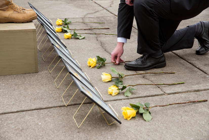 A member of the 628th Security Forces Squadron places a yellow rose during a National Police Week ceremony May 20, 2016, at the base flag pole on Joint Base Charleston – Air Base, S.C.  In honor of Police Week, the 628th SFS collaborated with multiple base agencies to conduct various events to remember and celebrate their fallen brothers and sisters in law enforcement. (U.S. Air Force Photo/Airman 1st Class Haleigh Laverty)