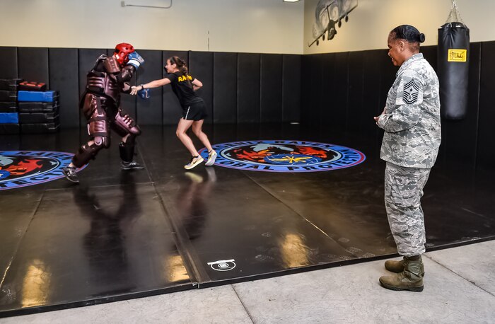 Command Chief Master Sgt. Shelina Frey, Air Mobility Command chief, watches a 628th Security Forces Phoenix Raven demonstration during her visit to Joint Base Charleston May 22 - 27, 2016. The 628th SFS Phoenix Ravens consist of all volunteer teams of specially trained security forces personnel dedicated to providing security AMC aircraft while transitioning through high terrorist and criminal threat areas. (U.S Air Force Photo/Airman Megan Munoz)