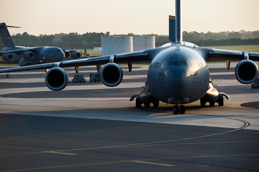 Two of 10 C-17 Globemaster IIIs taxi during a large formation exercise as part of Crescent Reach 16, May 26, 2016, at Joint Base Charleston, S.C. The exercise tested JB Charleston’s ability to launch a large aircraft formation and mobilize a large amount of cargo and passengers. (U.S. Air Force photo/Staff Sgt. Jared Trimarchi)