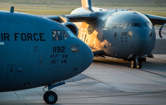 A pilot looks out the window of a C-17 Globemaster III during a large formation exercise as part of Crescent Reach 16, May 26, 2016, at Joint Base Charleston, S.C. The exercise tested JB Charleston’s ability to launch a large aircraft formation and mobilize a large amount of cargo and passengers. (U.S. Air Force photo/Staff Sgt. Jared Trimarchi)