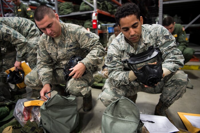 Airmen inspect their deployment gear as part of Exercise Crescent Reach 16, May 24, 2016, at Joint Base Charleston, S.C. The exercise tested JB Charleston’s ability to launch a large aircraft formation and mobilize a large amount of cargo and passengers. (U.S. Air Force photo/Staff Sgt. Jared Trimarchi)