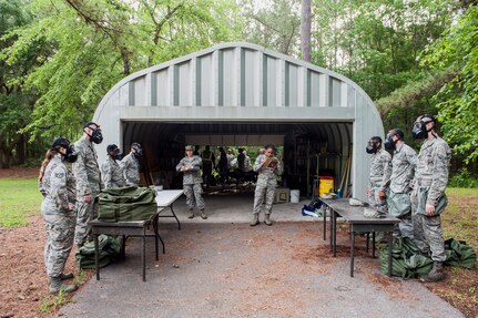 Airmen are evaluated on donning gas masks during a chemical, biological, radiological, nuclear and explosives drill as part of Exercise Crescent Reach 16, May 19, 2016, at Joint Base Charleston, S.C. The exercise tested JB Charleston’s ability to launch a large aircraft formation and mobilize a large amount of cargo and passengers. (U.S. Air Force photo/Staff Sgt. Jared Trimarchi)