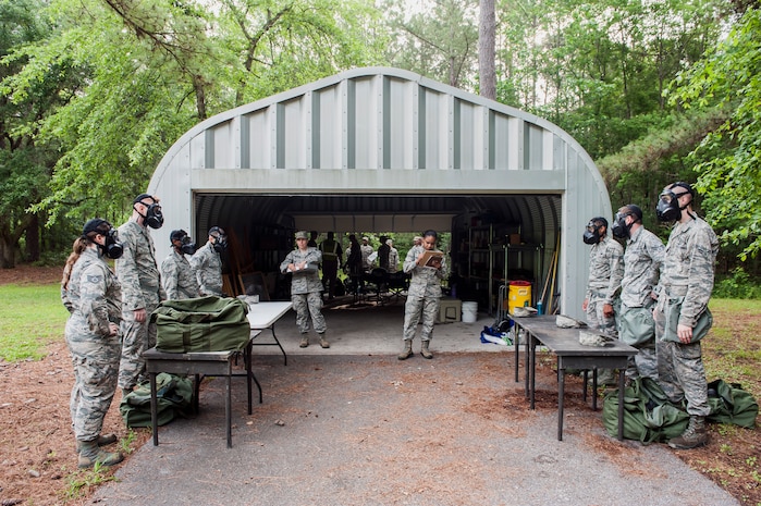 Airmen are evaluated on donning gas masks during a chemical, biological, radiological, nuclear and explosives drill as part of Exercise Crescent Reach 16, May 19, 2016, at Joint Base Charleston, S.C. The exercise tested JB Charleston’s ability to launch a large aircraft formation and mobilize a large amount of cargo and passengers. (U.S. Air Force photo/Staff Sgt. Jared Trimarchi)