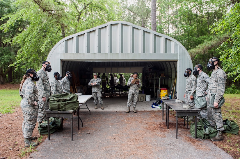 Airmen are evaluated on donning gas masks during a chemical, biological, radiological, nuclear and explosives drill as part of Exercise Crescent Reach 16, May 19, 2016, at Joint Base Charleston, S.C. The exercise tested JB Charleston’s ability to launch a large aircraft formation and mobilize a large amount of cargo and passengers. (U.S. Air Force photo/Staff Sgt. Jared Trimarchi)